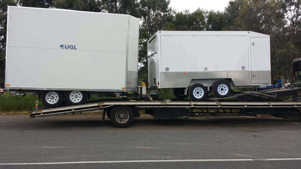 Auto Mover Transporting Two Enclosed Trailers Interstate