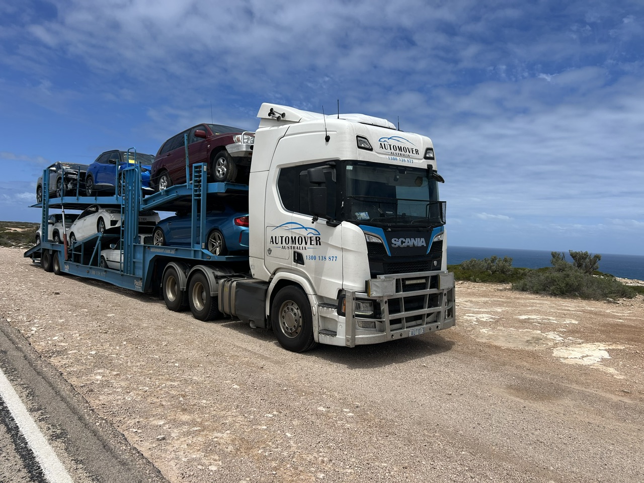 Auto Mover Scania truck carrying multi-vehicle transport trailer