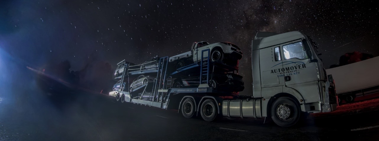 Auto Mover Car Carrier Transporting Multiple Vehicles at Night