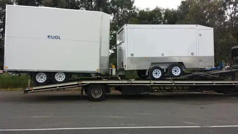 Auto Mover Transporting Two Enclosed Trailers Interstate