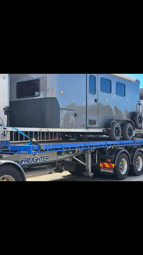 Auto Mover Blue Caravan Secured on Freighter Flatbed