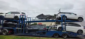 Multi-Level Car Carrier Transporting SUVs and Jet Ski