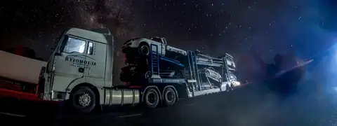 Auto Mover Car Carrier Transporting Multiple Vehicles at Night
