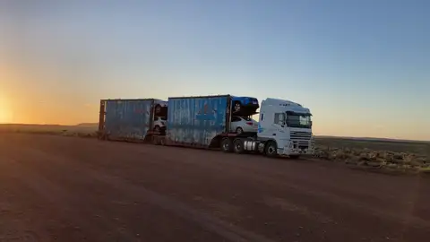 Auto Mover Scania Truck Transporting Multiple Vehicles at Sunset