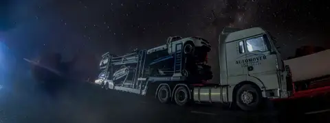 Auto Mover Car Carrier Transporting Multiple Vehicles at Night