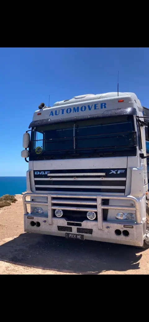 Auto Mover DAF XF truck parked at coastal location