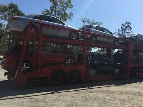 Auto Mover Red Car Carrier with Multiple Vehicles Loaded