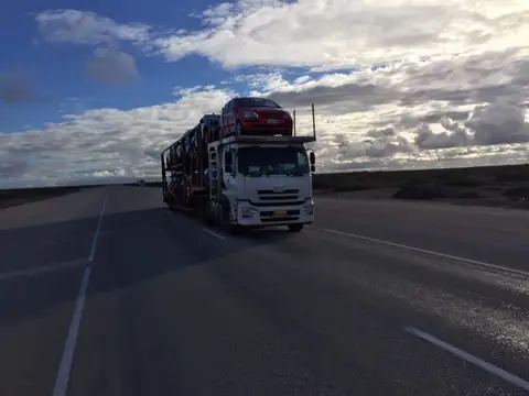 Auto Mover Red Sedan on Multi-Car Transport Carrier