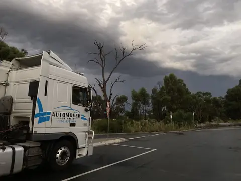 Auto Mover Transport Truck Rest Stop Storm Clouds