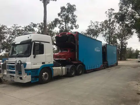 Auto Mover Transporting Classic Red Jeep on Enclosed Trailer