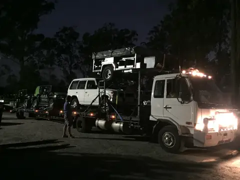 Auto Mover Transporting White SUV on Hydraulic Car Carrier