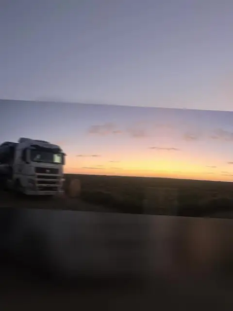 Auto Mover Truck on Highway at Sunset