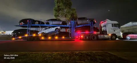 Car Carrier Truck Loaded with Multiple Vehicles at Night