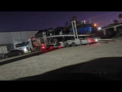 Auto Mover car transport – Car Carrier Truck Parked at Dusk Depot