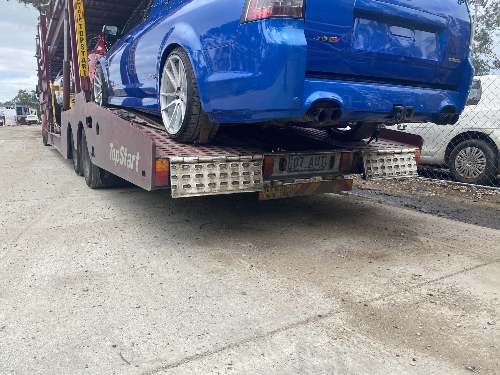 Auto Mover Blue Sports Car Loaded on Transport Carrier
