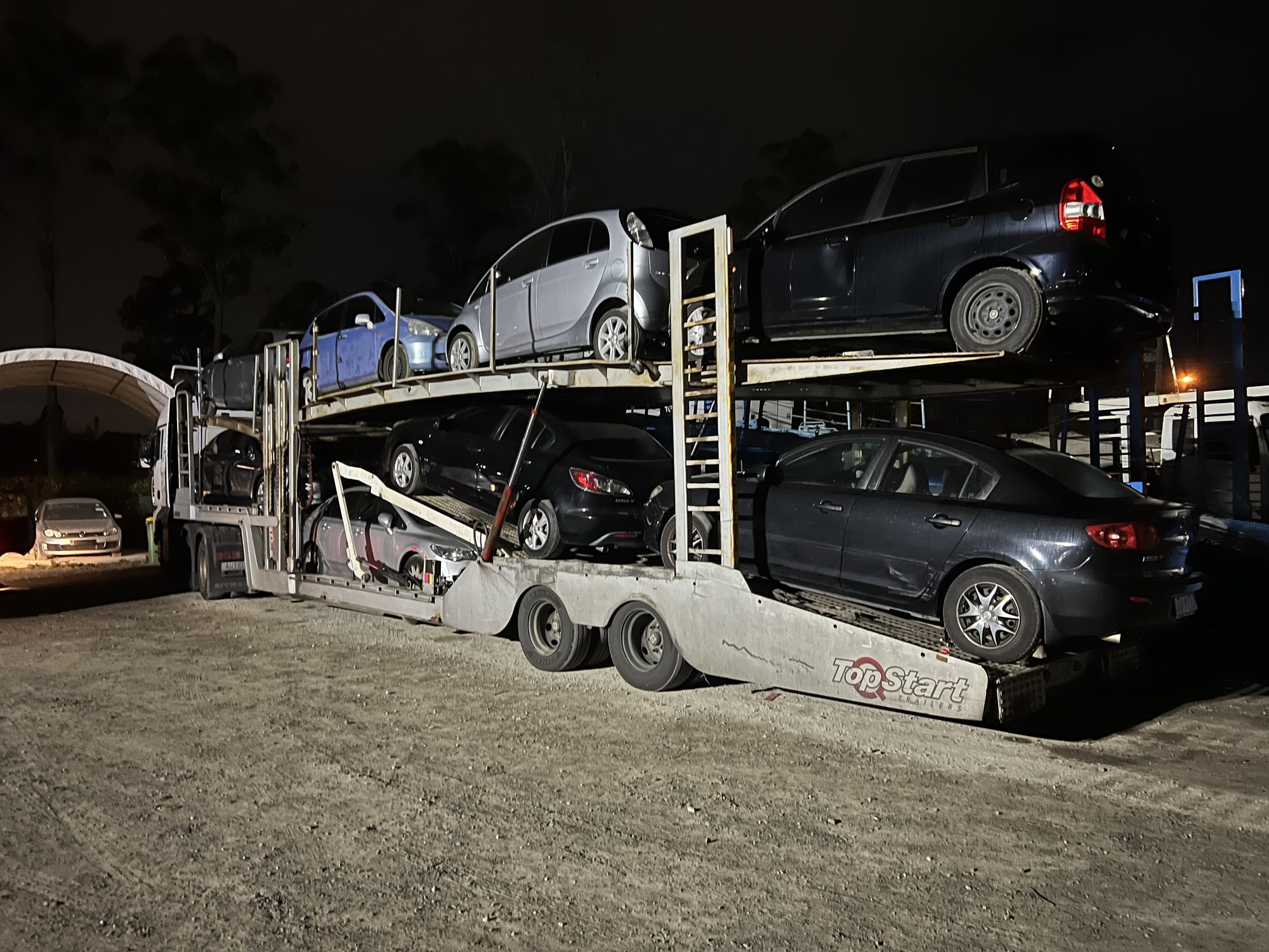 Auto Mover Car Carrier Loaded with Multiple Vehicles at Night
