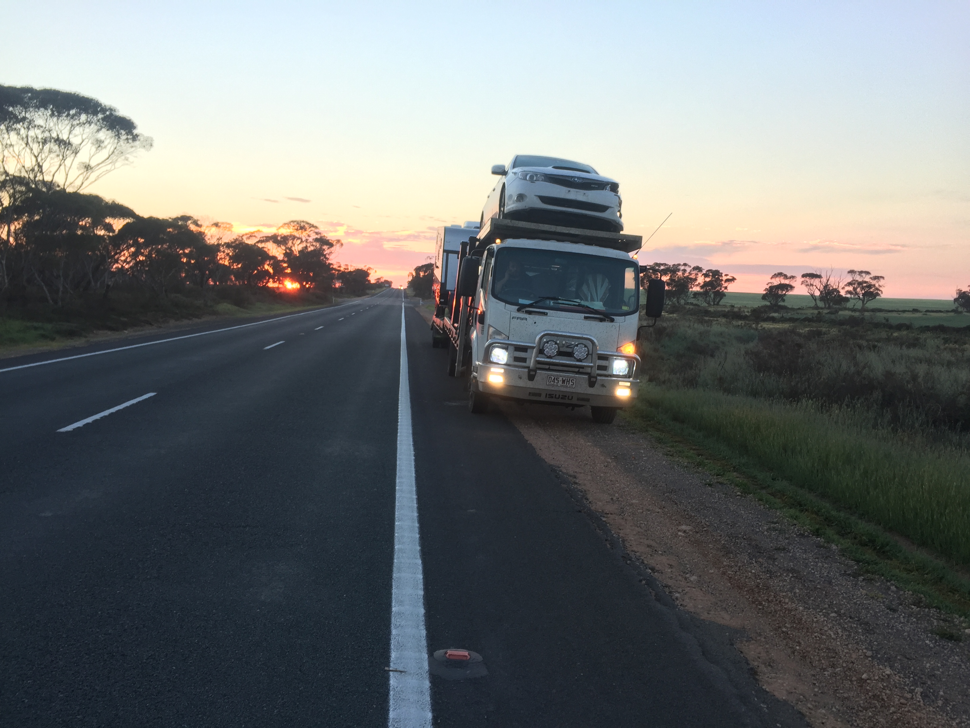 Auto Mover Car Carrier Transporting Vehicles at Dusk