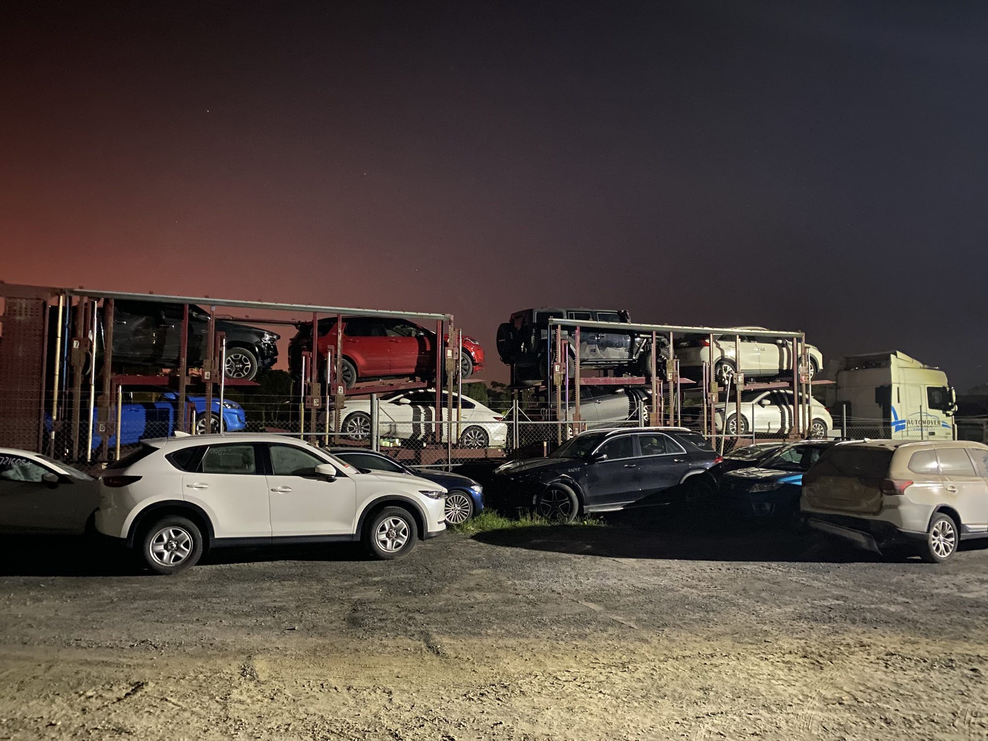Auto Mover Car Carriers Loaded with Vehicles at Night