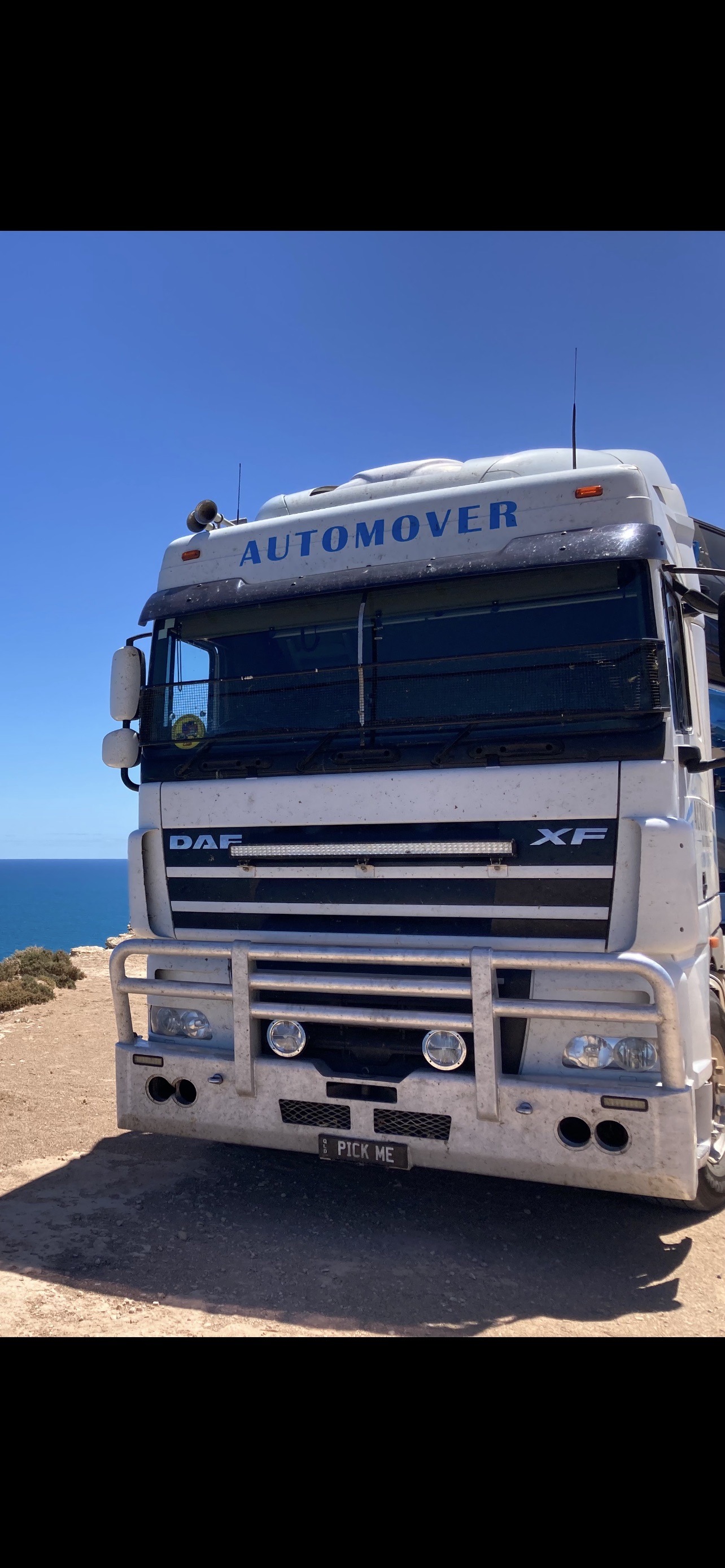 Auto Mover DAF XF truck parked at coastal location