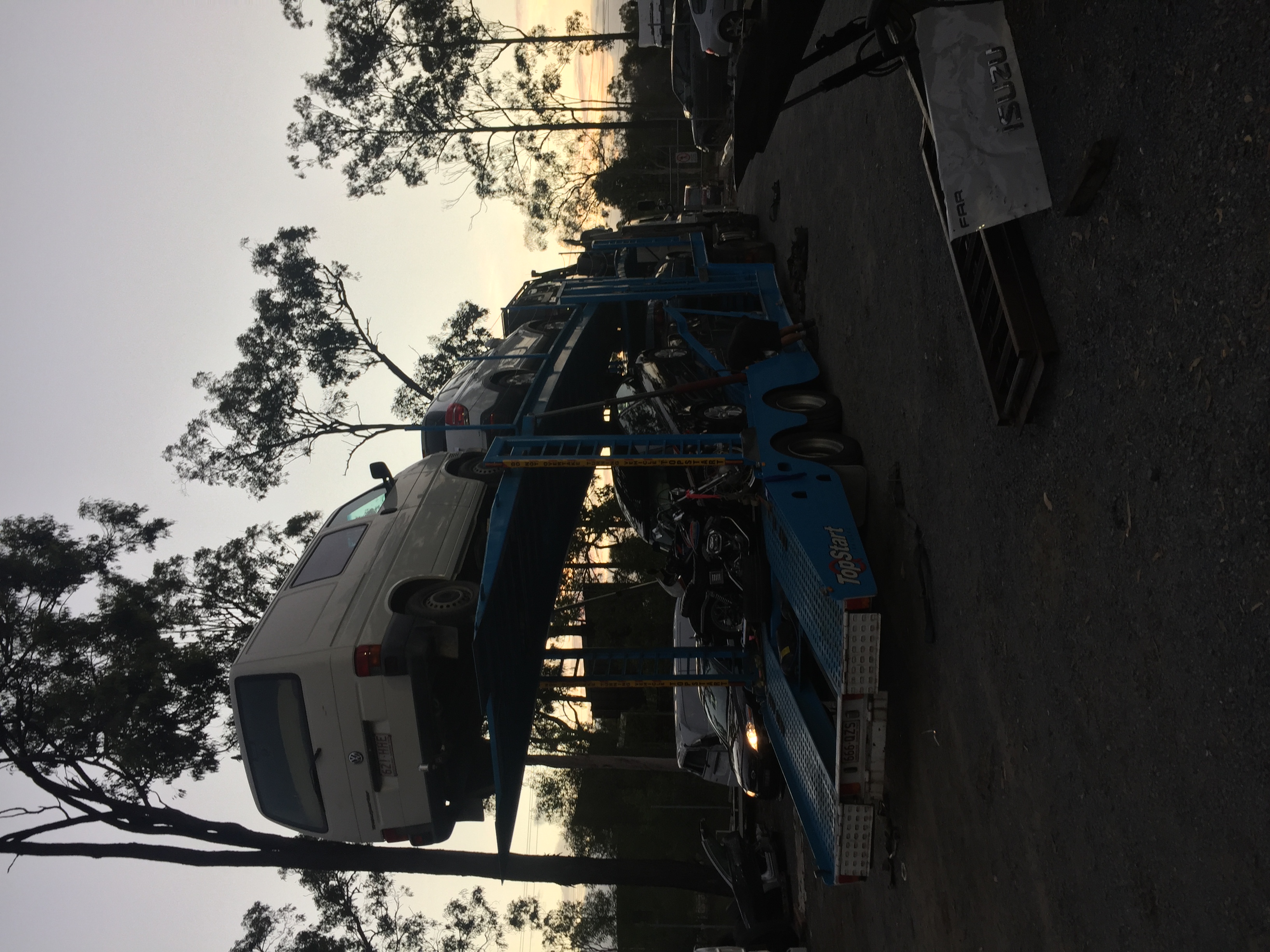 Auto Mover Double Deck Carrier Loading Vehicles at Dusk