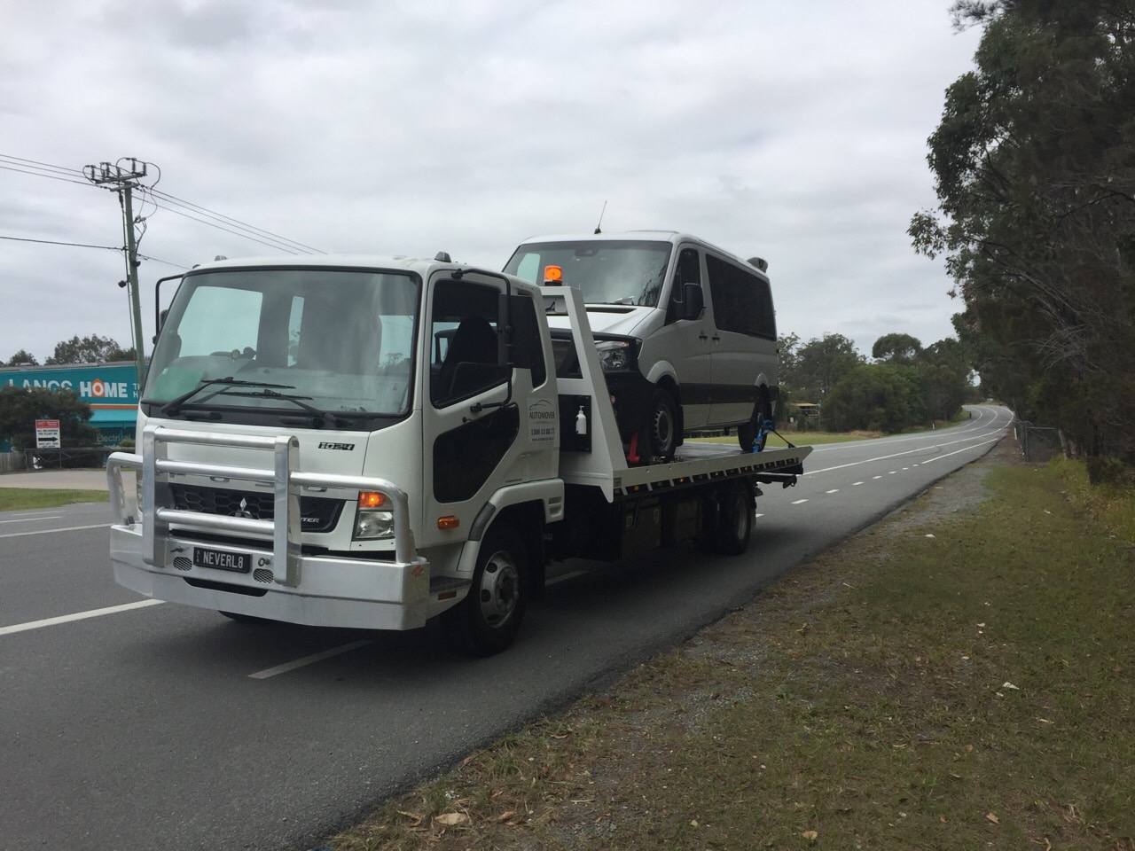 Auto Mover Isuzu Truck Transporting Vehicle on Highway