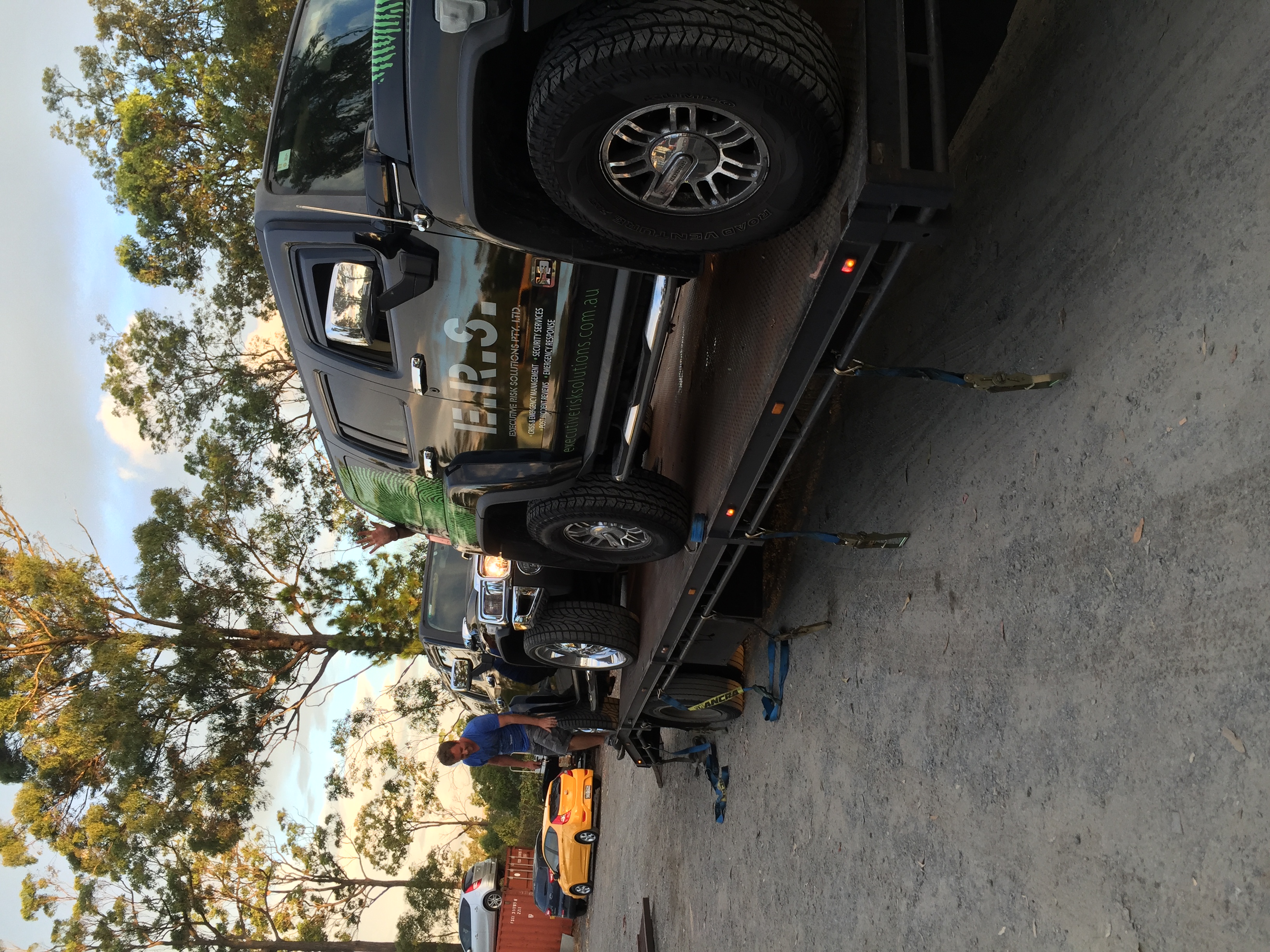 Auto Mover Loading Yellow Sports Car onto Carrier