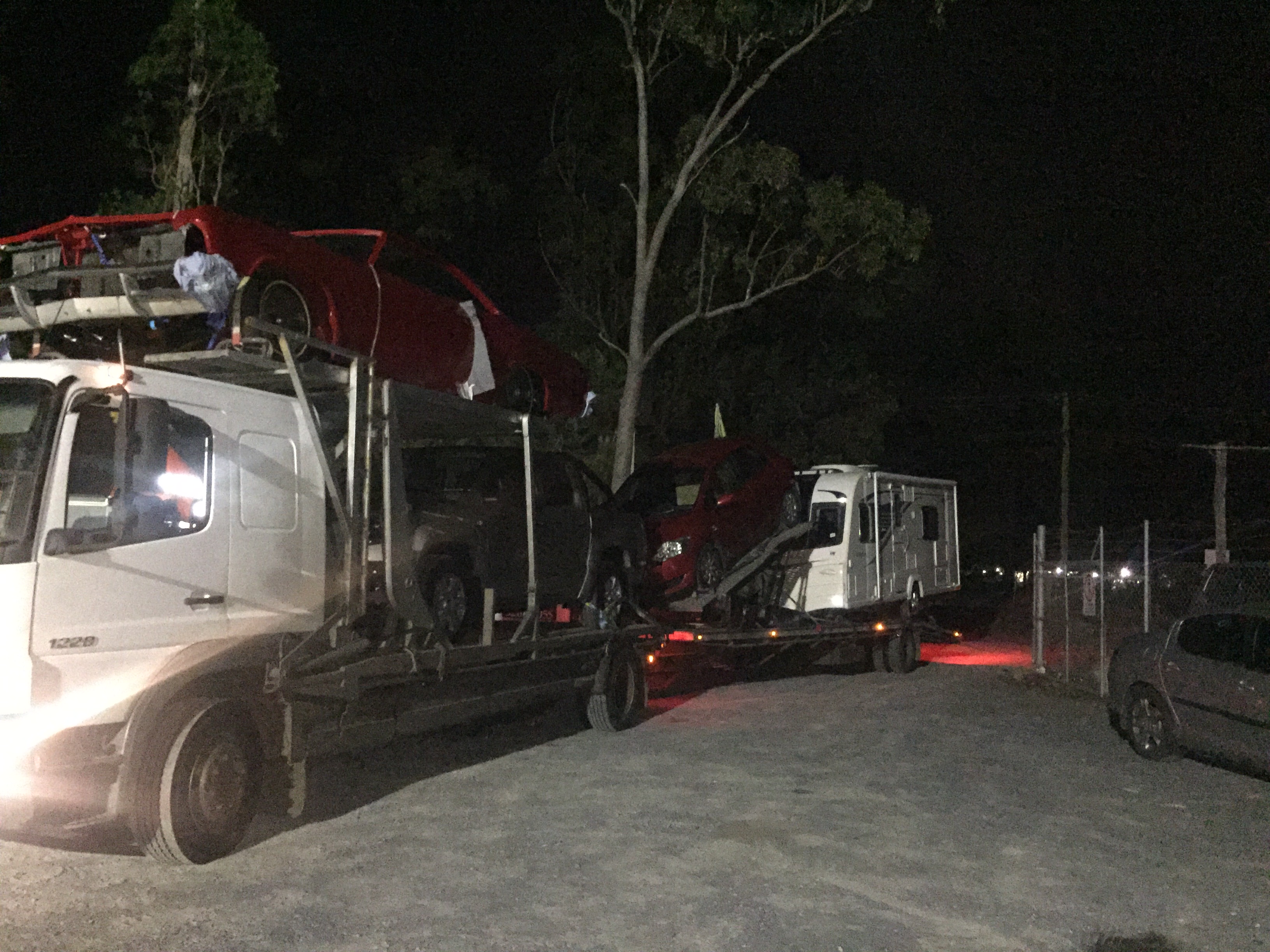 Auto Mover Red Sedan Loading onto Interstate Car Carrier