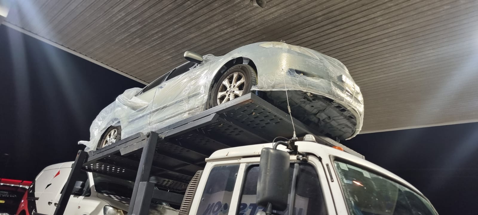 Auto Mover Silver Sedan Secured on Double-Deck Car Carrier