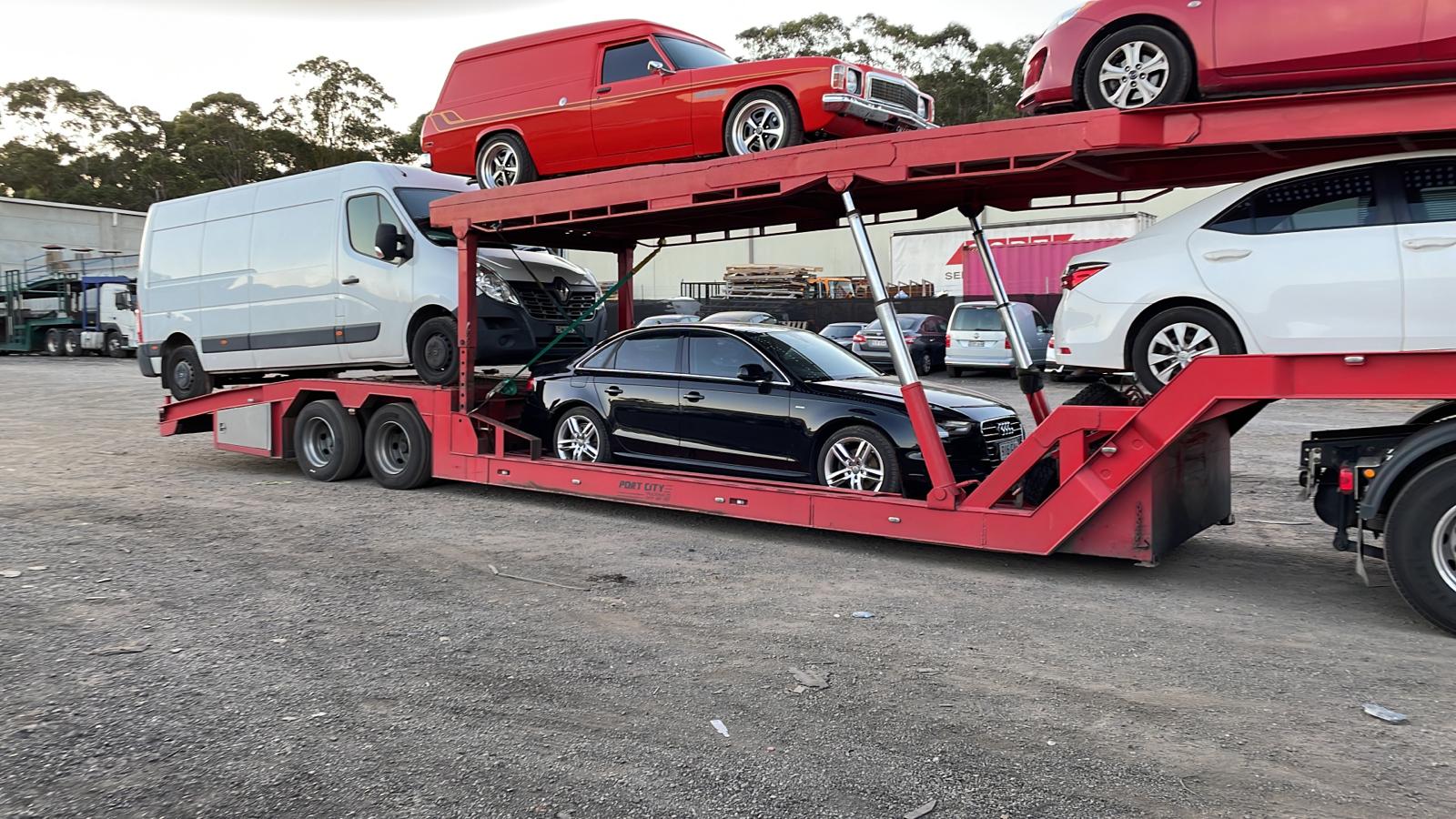 Auto Mover Transporting Black Audi Sedan on Car Carrier