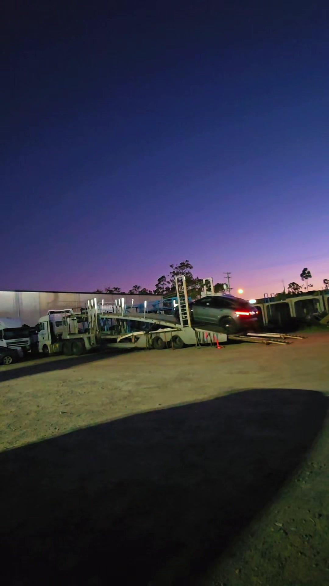 Auto Mover Vehicle Loaded on Transport Carrier at Dusk