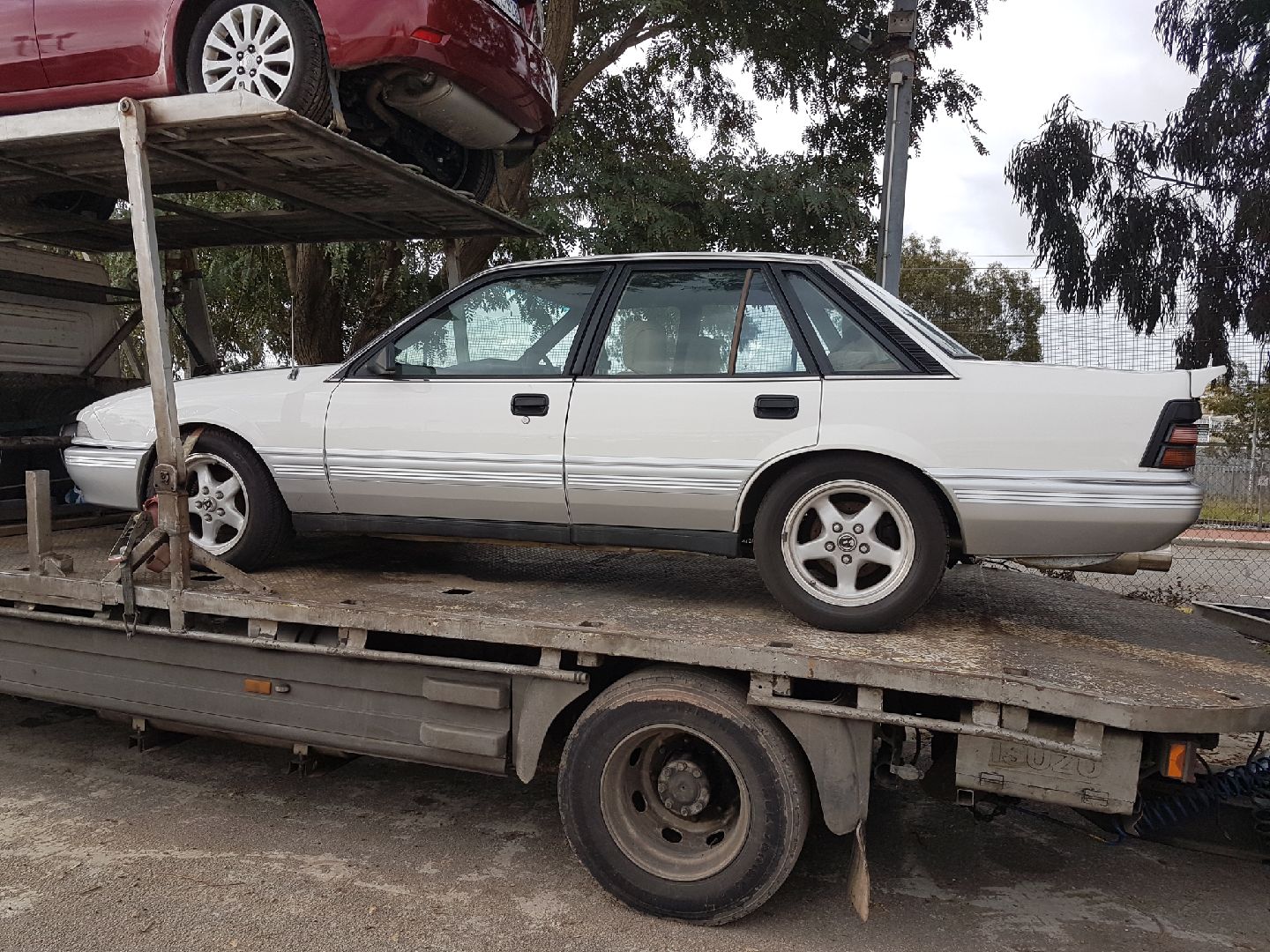 Auto Mover White Holden Sedan on Transport Truck