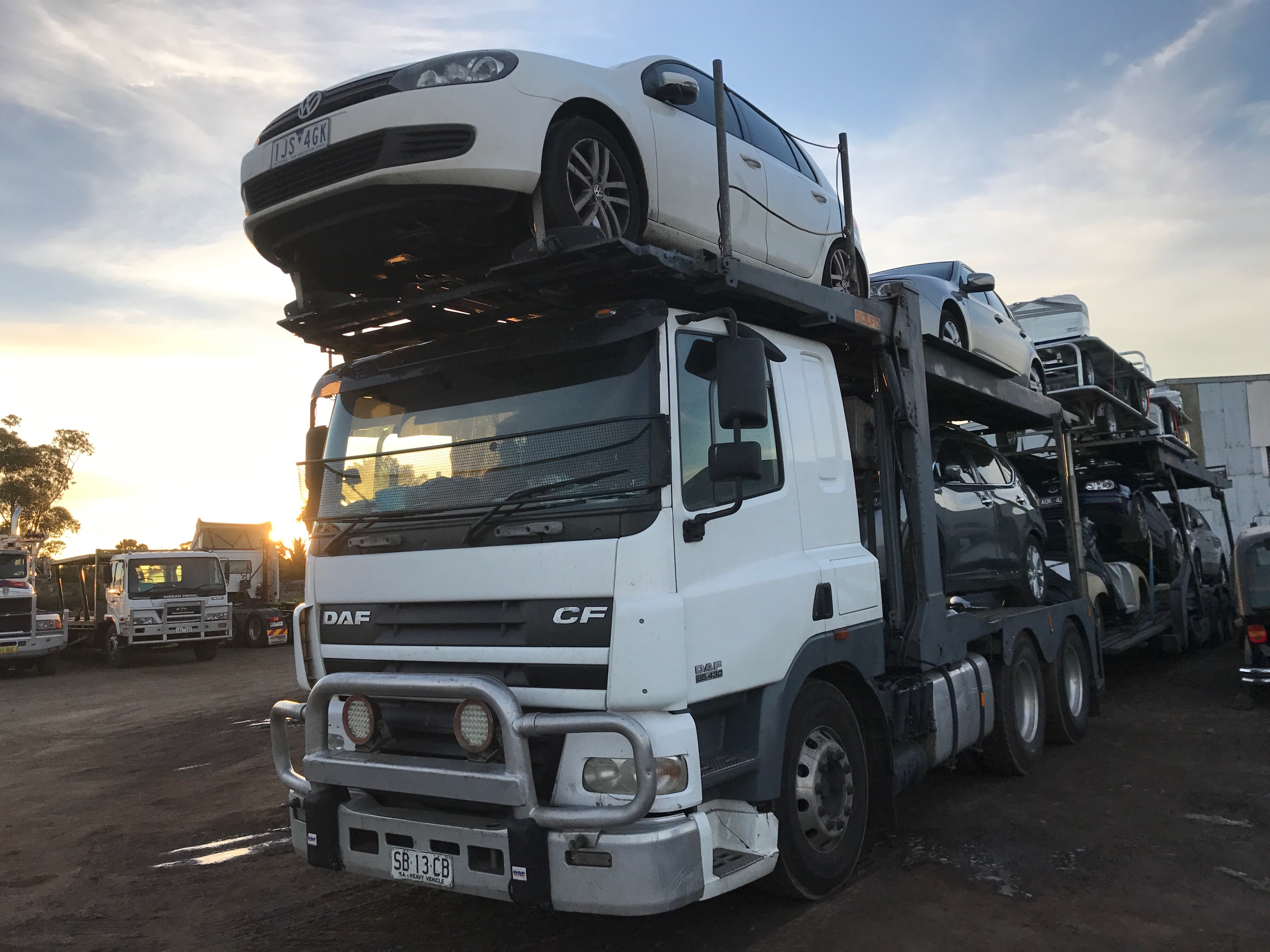 Auto Mover White Sedan Loaded on Car Carrier Truck