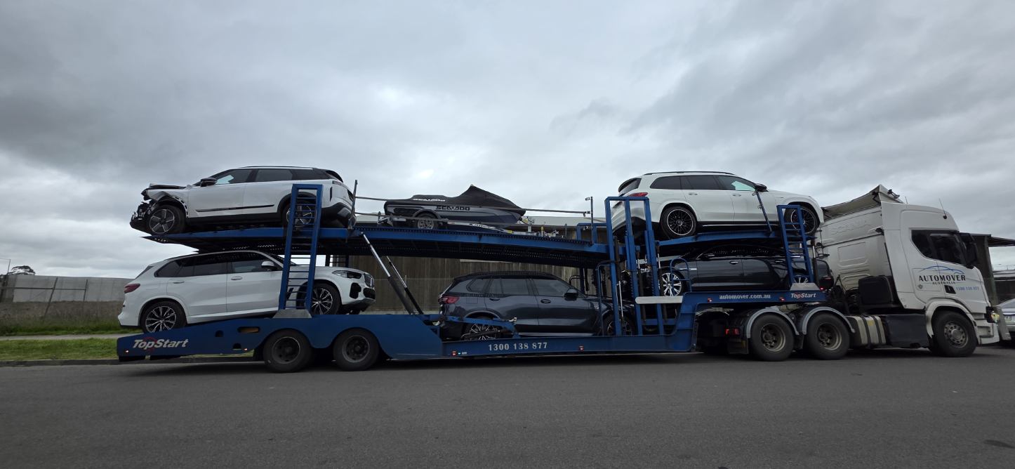 Car Carrier Loaded with SUVs and Watercraft